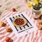 Chorizo a la Sidra – on Striped Tablecloth, Spanish Food Illustration, unframed on coastal sand