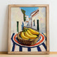 Banana – White village Outdoor Café Scene, Fruit Illustration, no-text version framed in wood