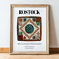 Rostock, Germany – Travel Poster, in wooden frame leaning on the floor